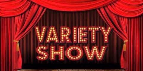 A red stage curtain drawn back and the words 'VARIETY SHOW' lit up in lights