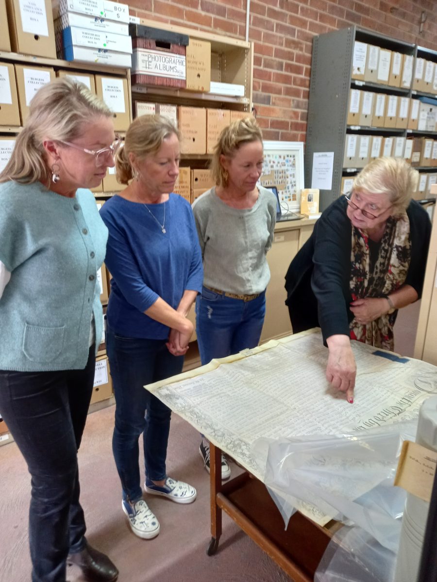 women looking at archives
