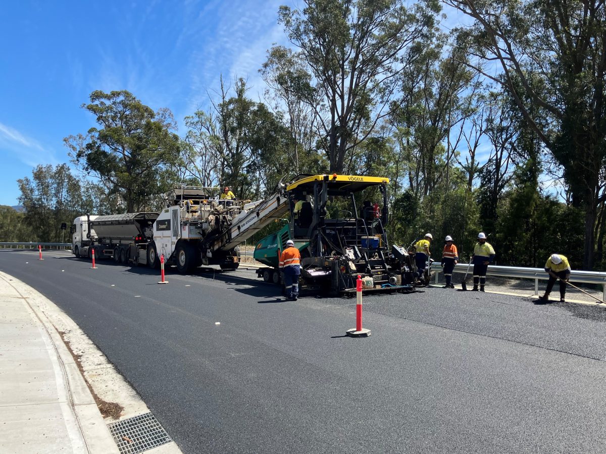 People re-asphalting a road