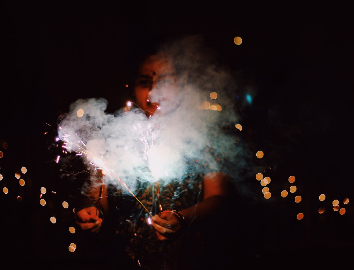 A girl lighting a sparkler at night