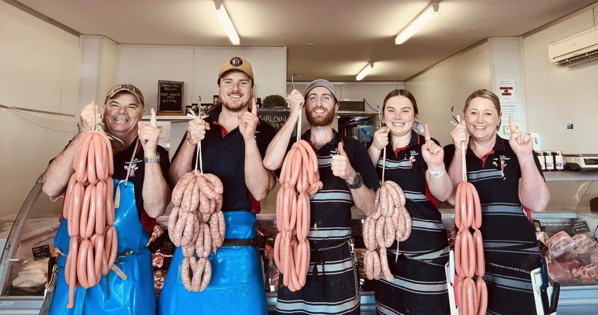 Butchers hbolding up sausages