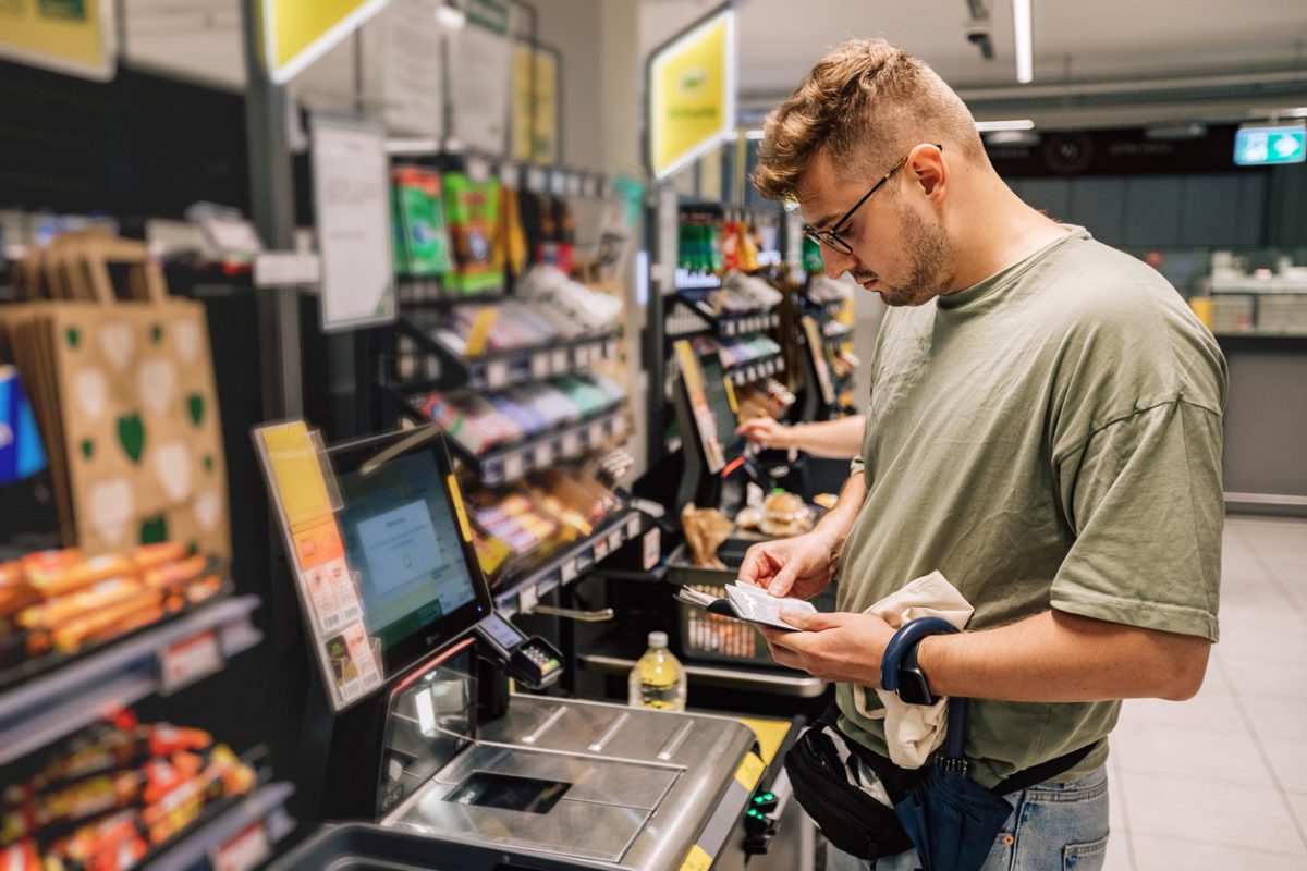 Man using a self serve checkout in a supermarket