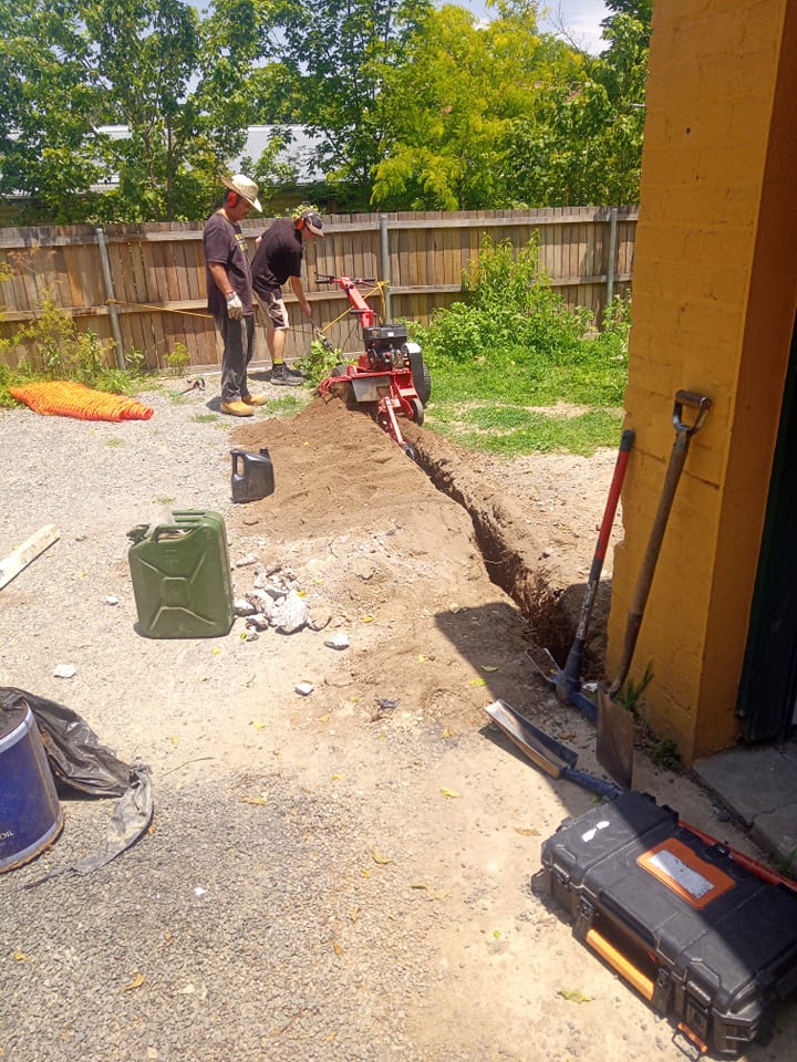 People working outside to dig into the ground