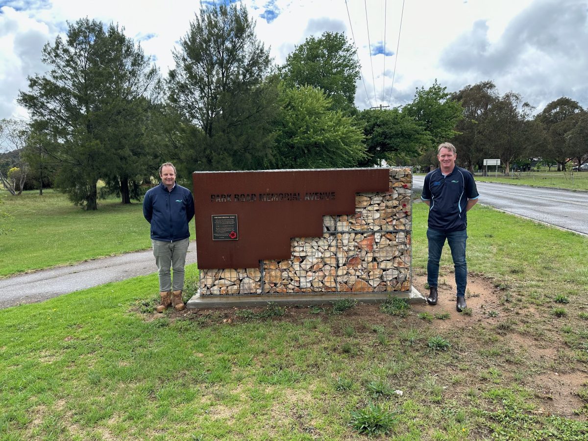 two men at war memorial wall