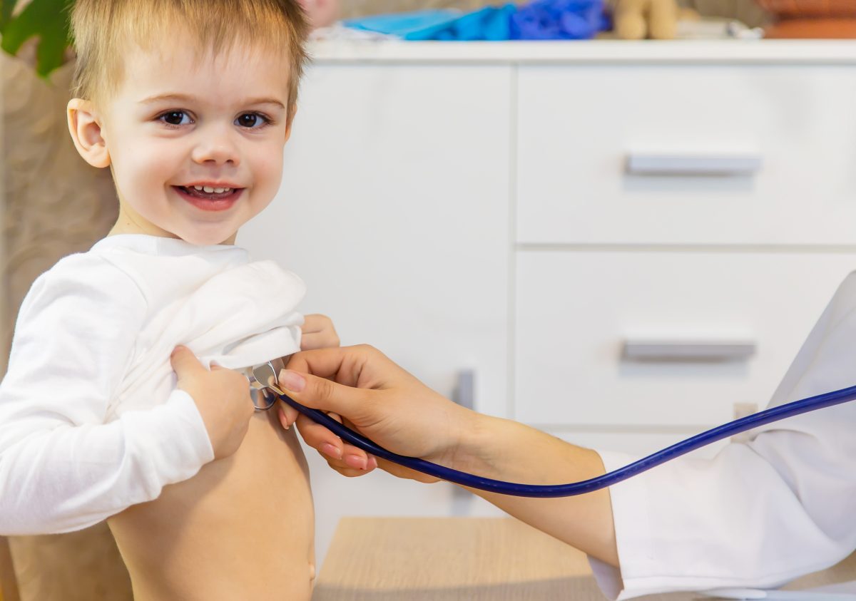 child being checked by a doctor