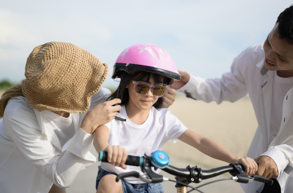 girl on bike with parents