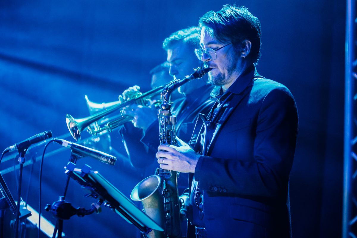 Musicians under blue light with their instruments