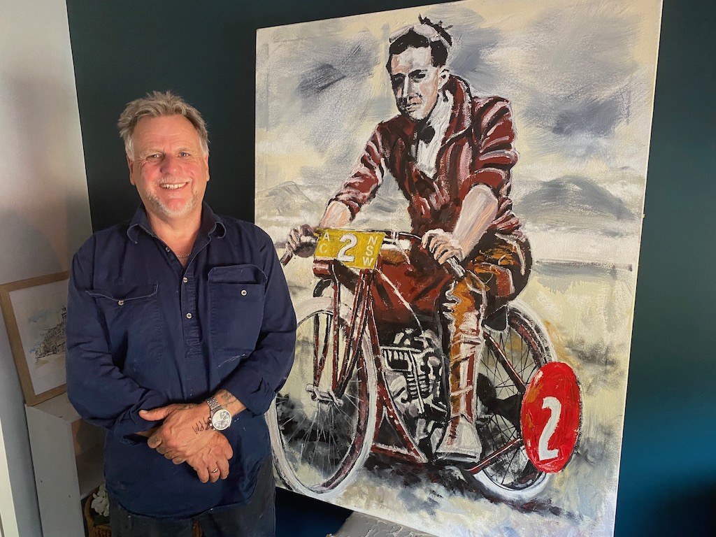 Tony ‘Skid’ Marks with his painting of Australian Motorcycle Grand Prix winner Dave Brewster on his Indian machine. 