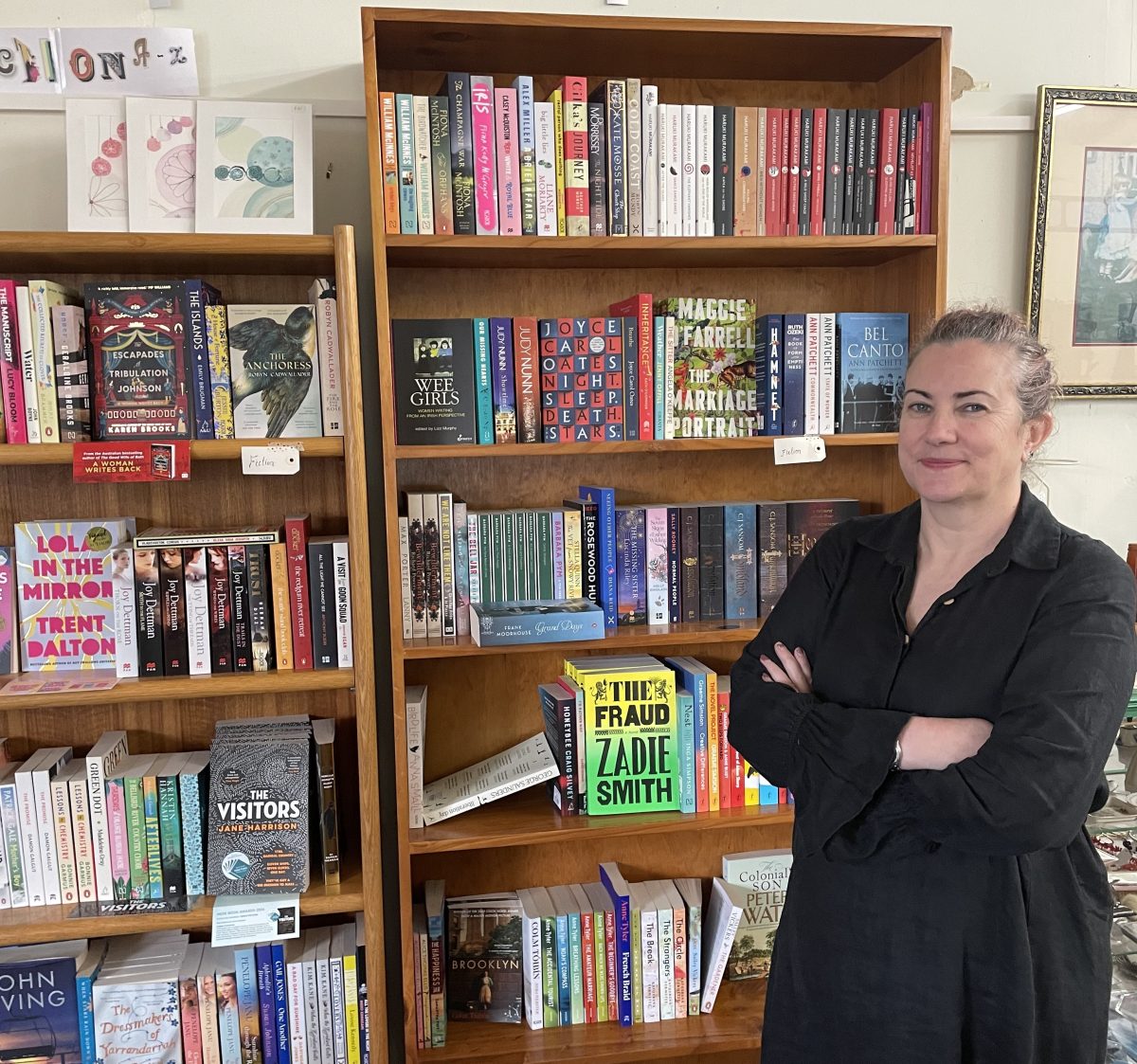Woman in front of shelves of books