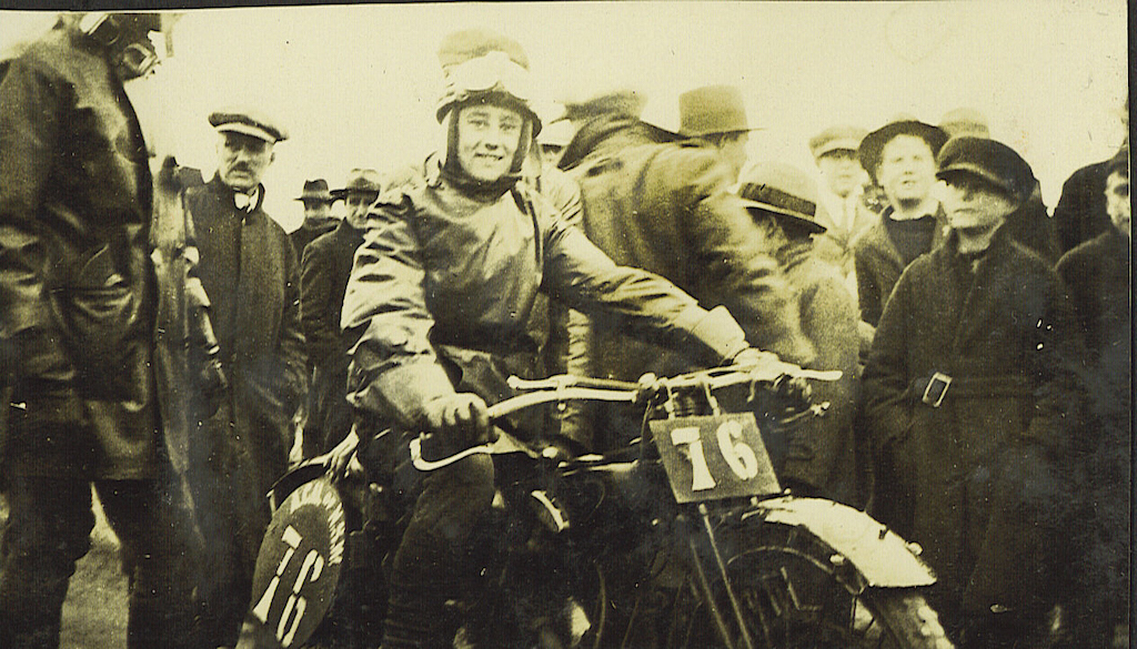 Rider, officials and crowd at motorcycle race in 1924