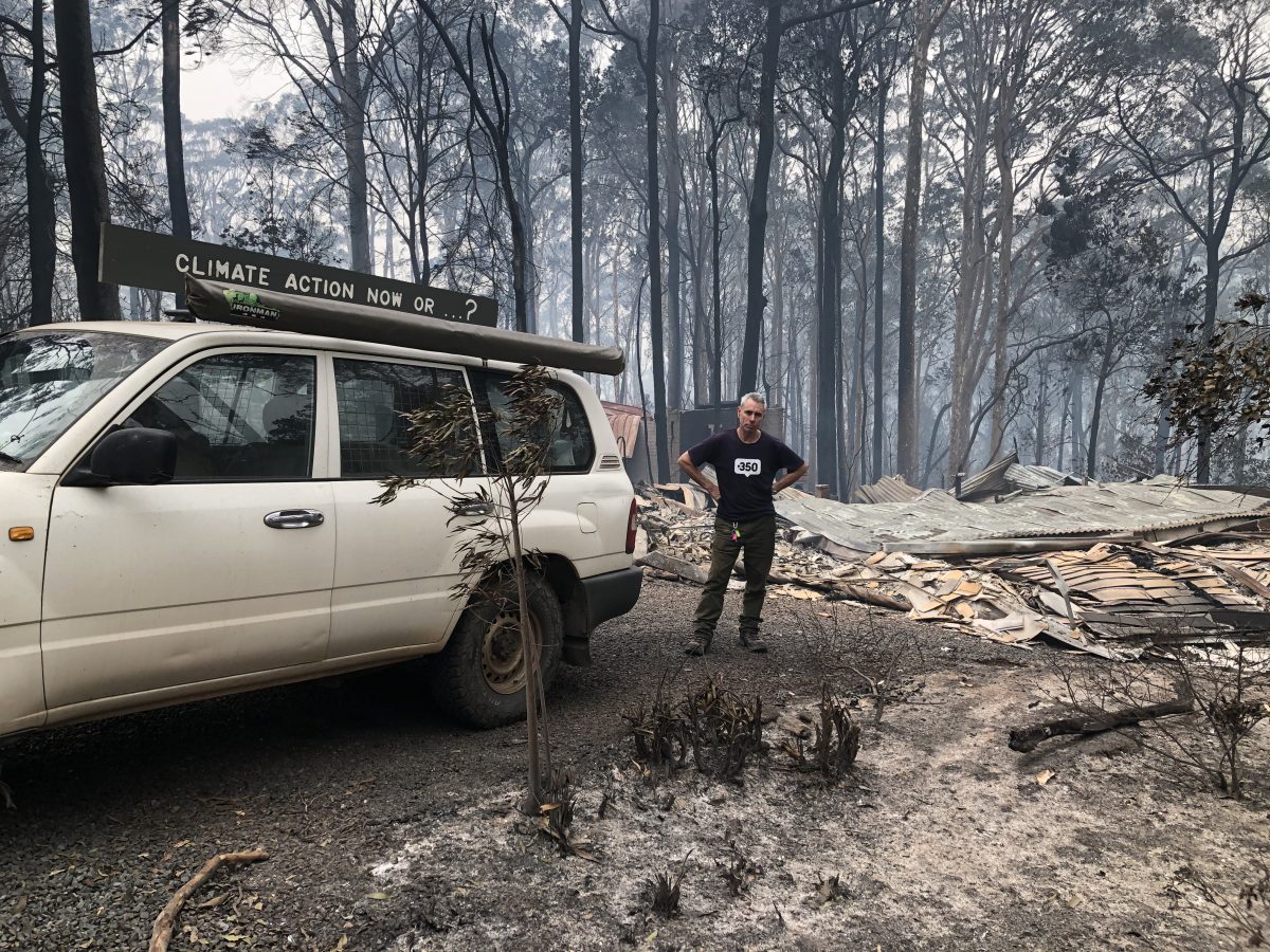 Jack Egan stands among the wreckage of his North Rosedale home after the Black Summer bushfires.