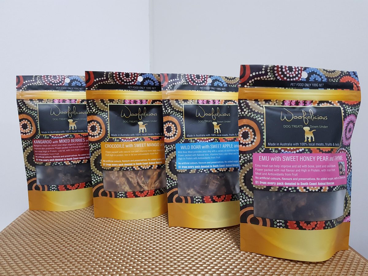 Four bags of dog treats products in a line