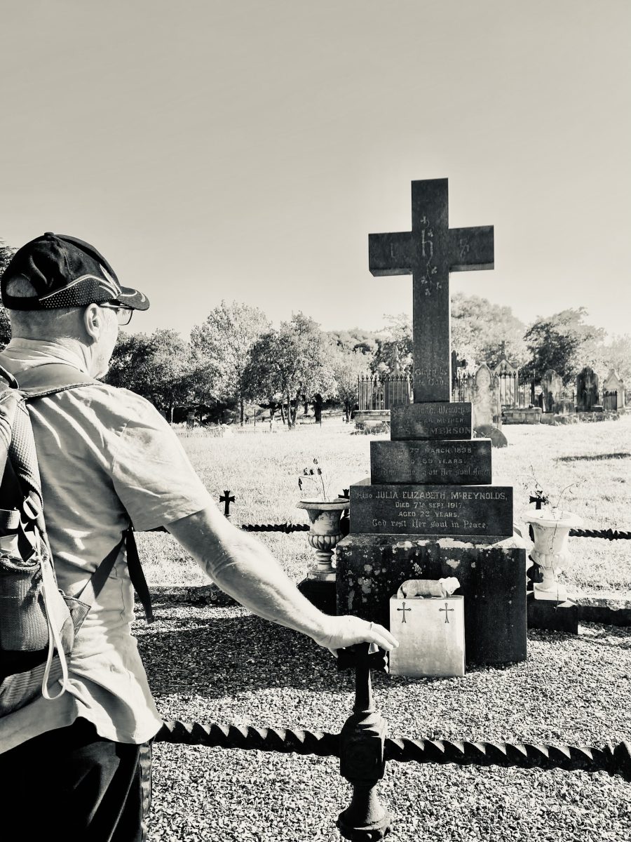 Man looking at gravesite