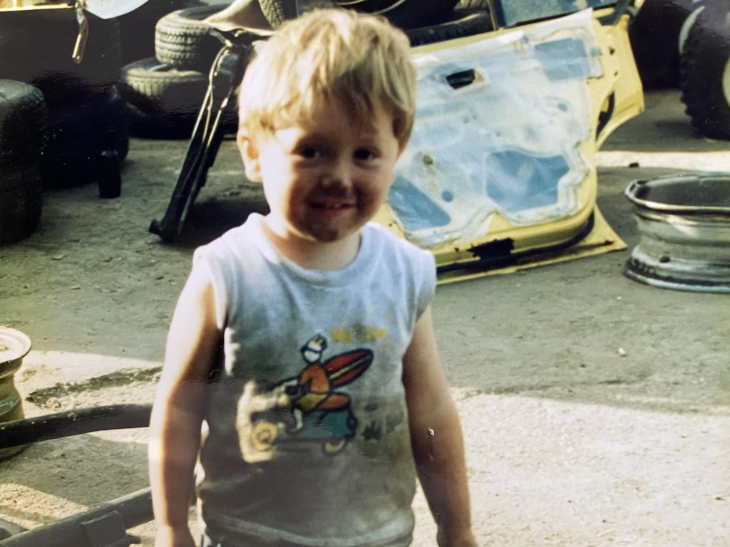 boy at car-wrecking yard