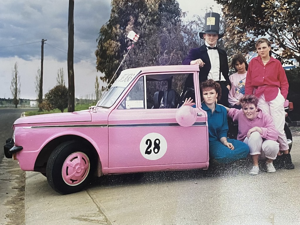 group of people with a modified car