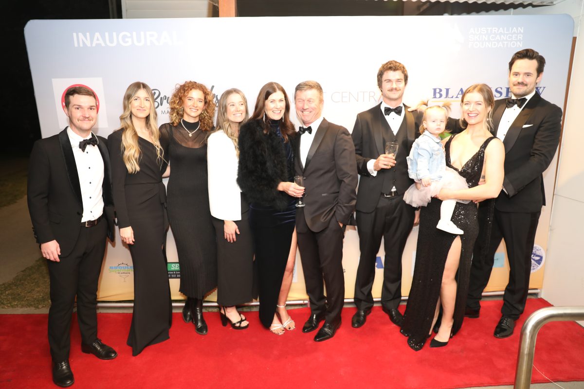 A group of people in black-tie clothing standing in a line