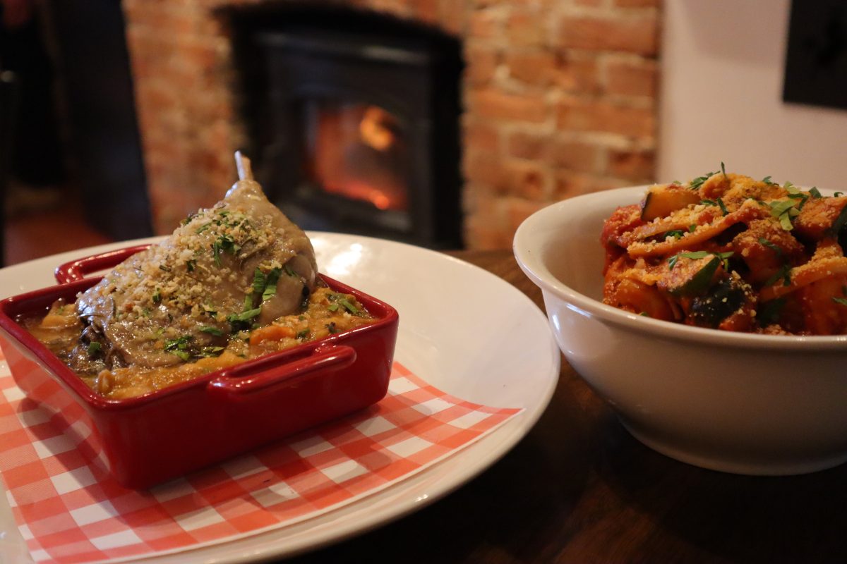 Two dishes of food next to fireplace