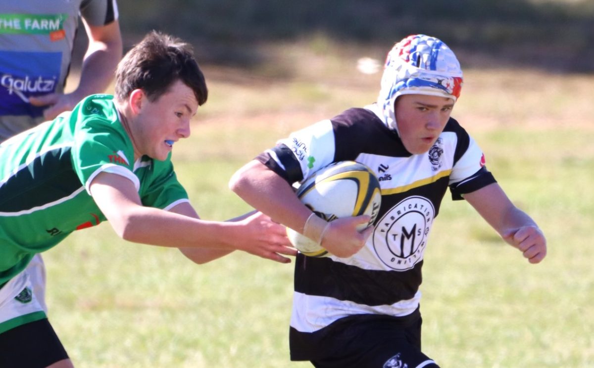 Two boys playing rugby