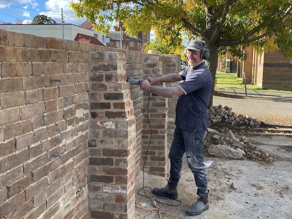 man working on a brick wall