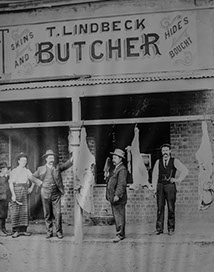 Old black and white photo of butcher shop