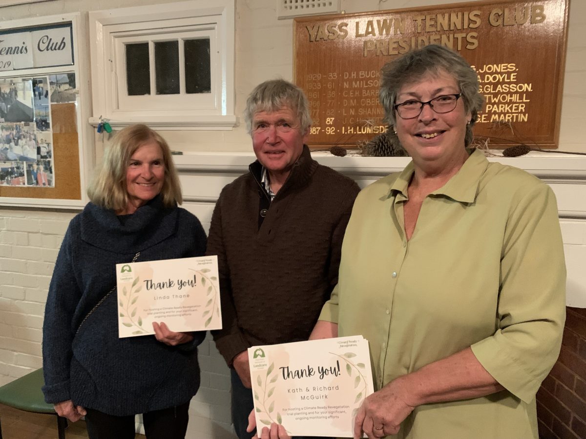 Two women and a man holding certificates.