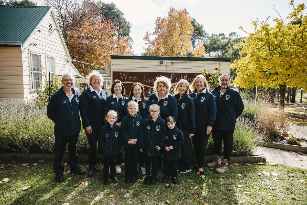 Kids and adults in front of Wee Jasper School sign