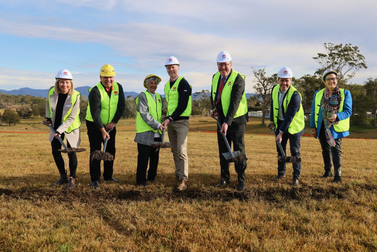 people officiate at a sod-turning ceremony