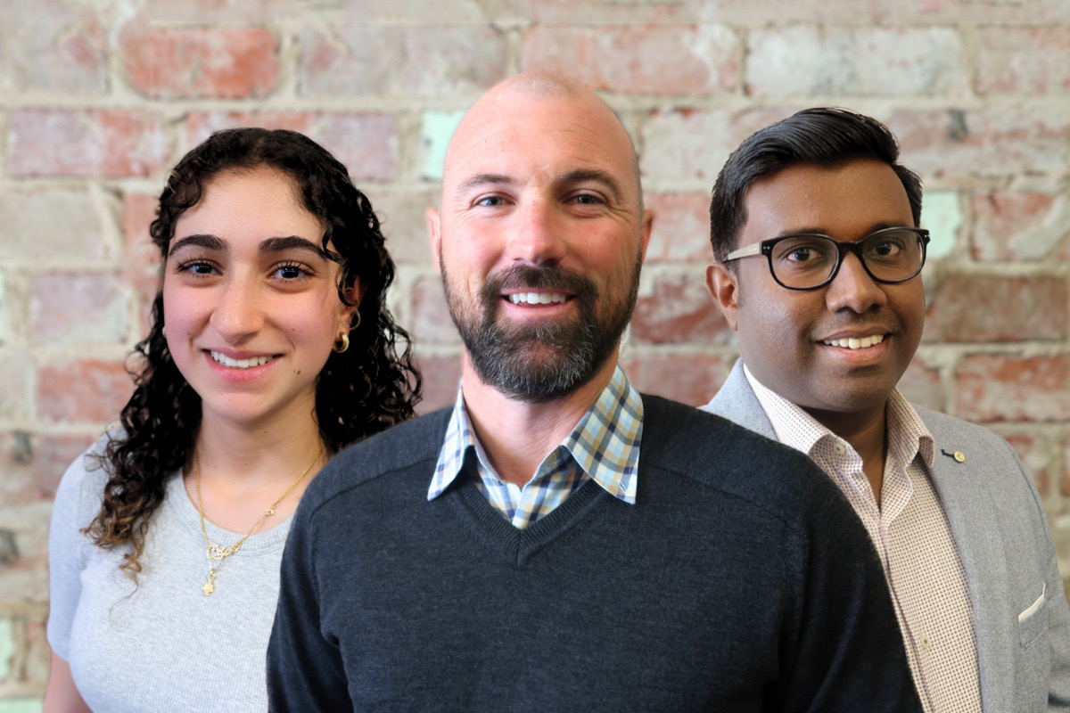 Three people smiling at the camera