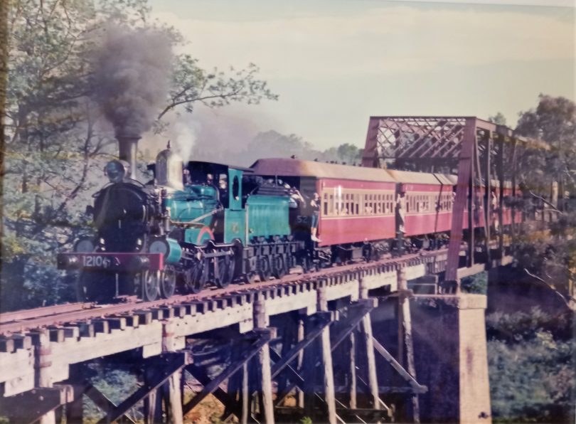 Train crossing wooden bridge