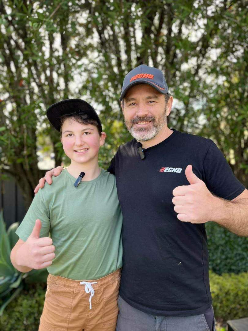 Man and boy give thumbs up