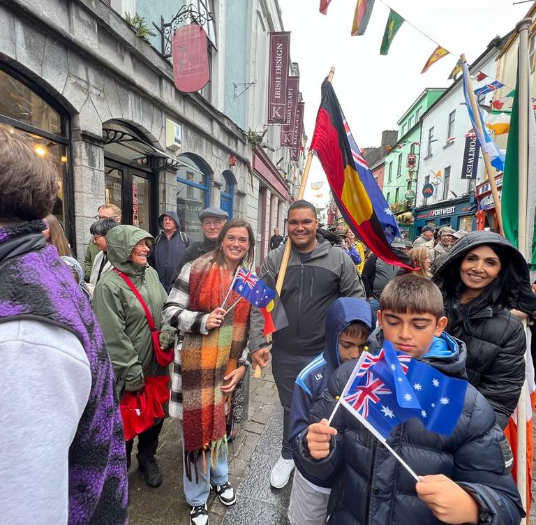 Sammy and Doody Dennis carrying the Australian and Aboriginal flags in the street parade in Galway in 2023.