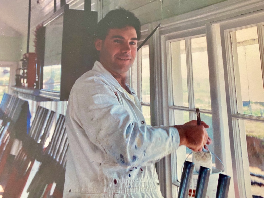 Greg O’Neill painting inside the railway signal box at Demondrille siding, near Harden.