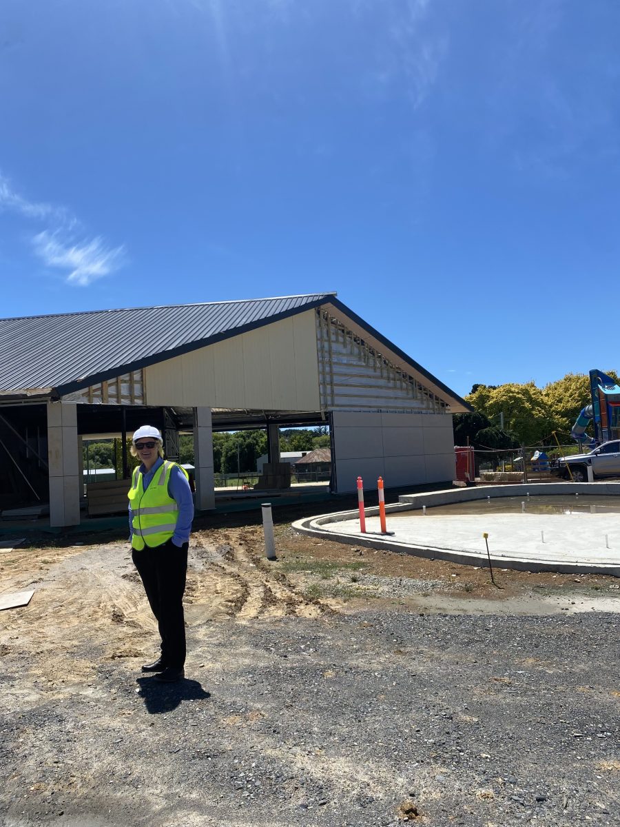 Woman in hard hat near swimming pool site