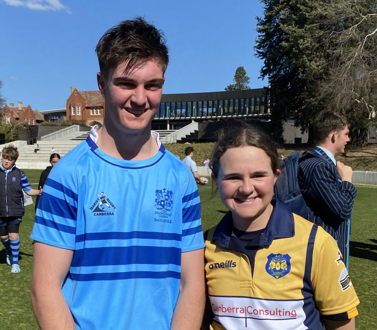 Boy and girl in rugby union shirts