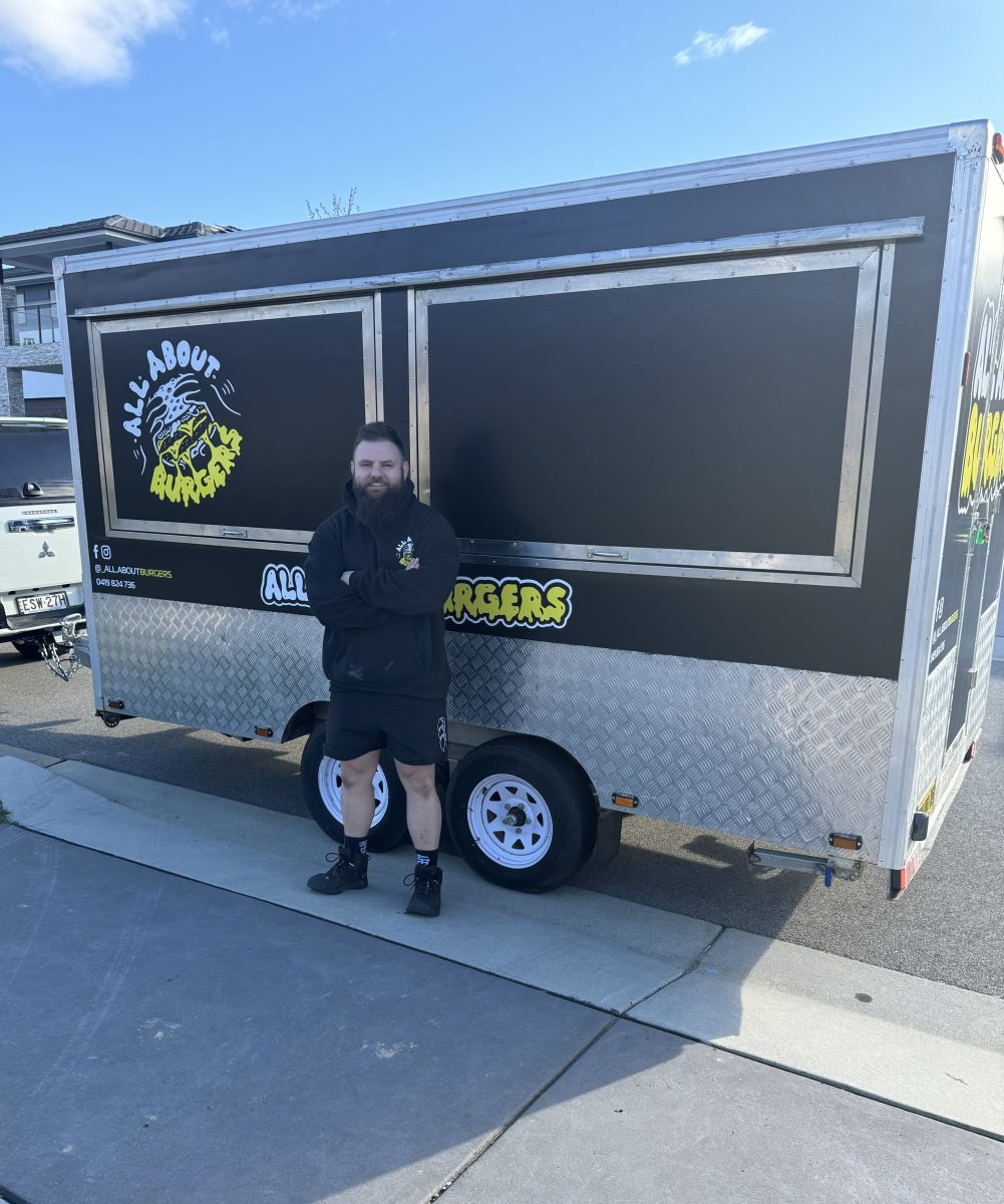 A man standing in front of a food truck