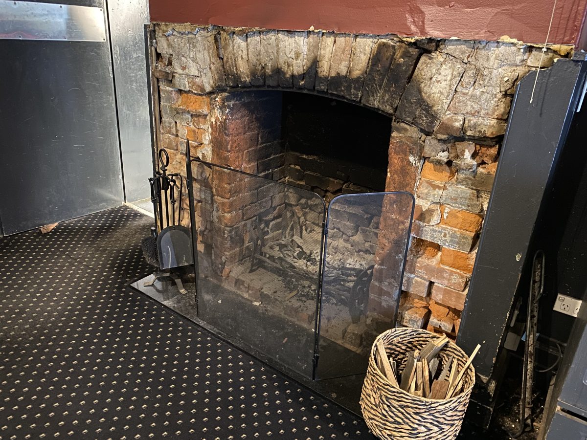 The open fireplace without its grey mantlepiece at the Southern Railway Hotel in Goulburn.