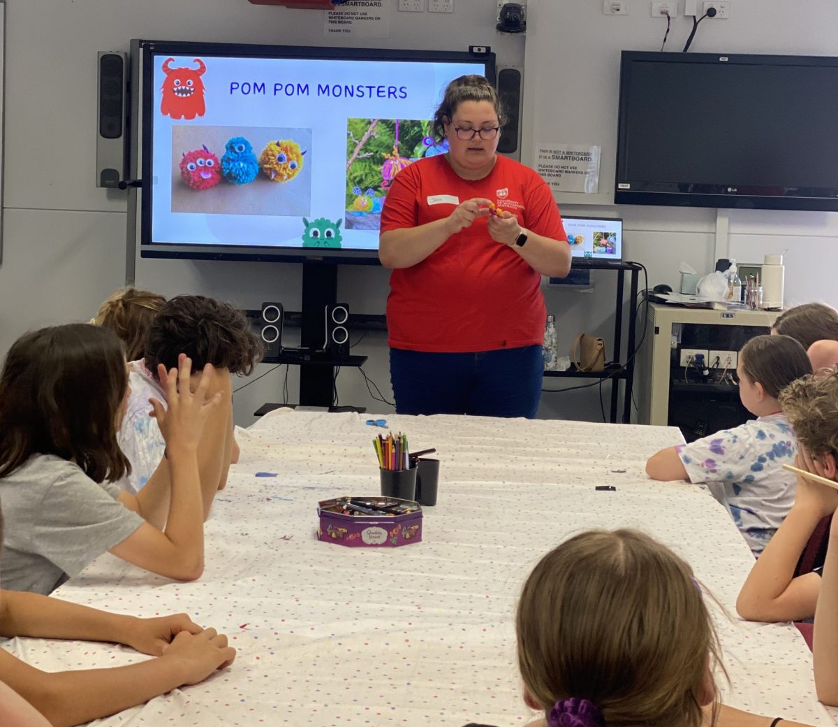 A UOW facilitator leads children in a creative class for Kids on Campus. 