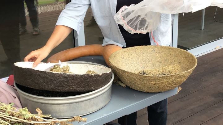 Woman reaching for a large bowl on a table