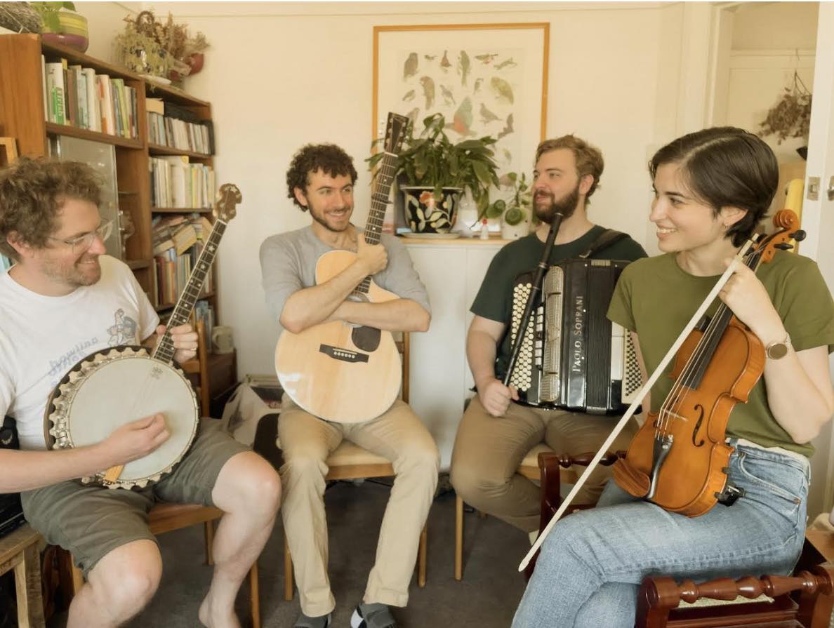 Four people holding their instruments