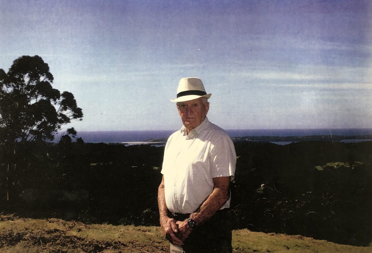 old man on a hill wearing a hat