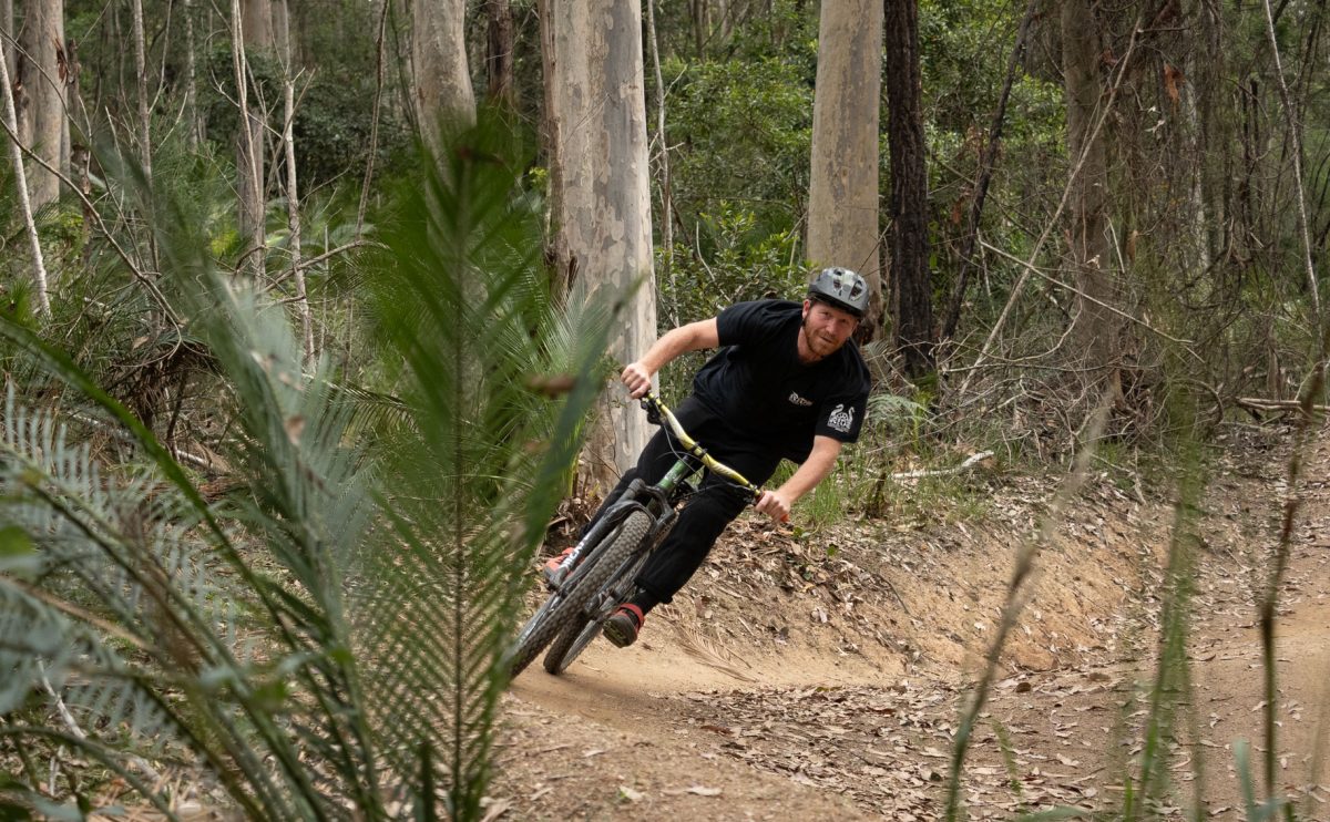 Mountain biker takes a berm.