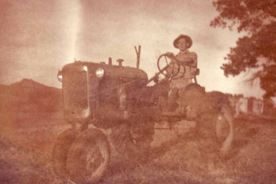 old photo of man on tractor