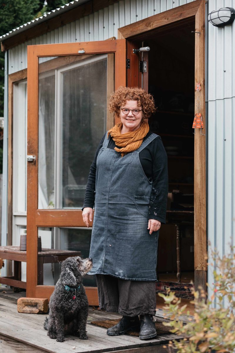 Woman and dog outside studio 