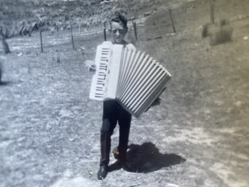 Aged about 11 or 12, Trevor Mills with his accordion. He became a proficient musician and played at bush dances at the Middle Arm Hall. 