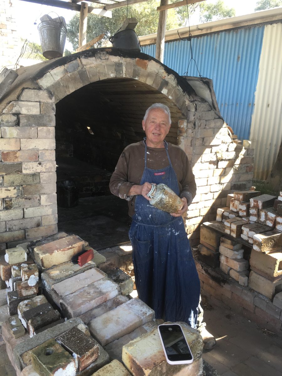 Man standing outside pottery kiln 