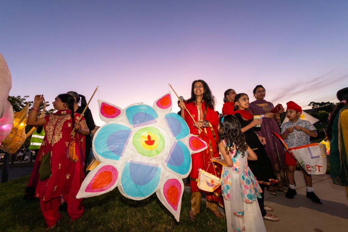 People at dusk holding kites