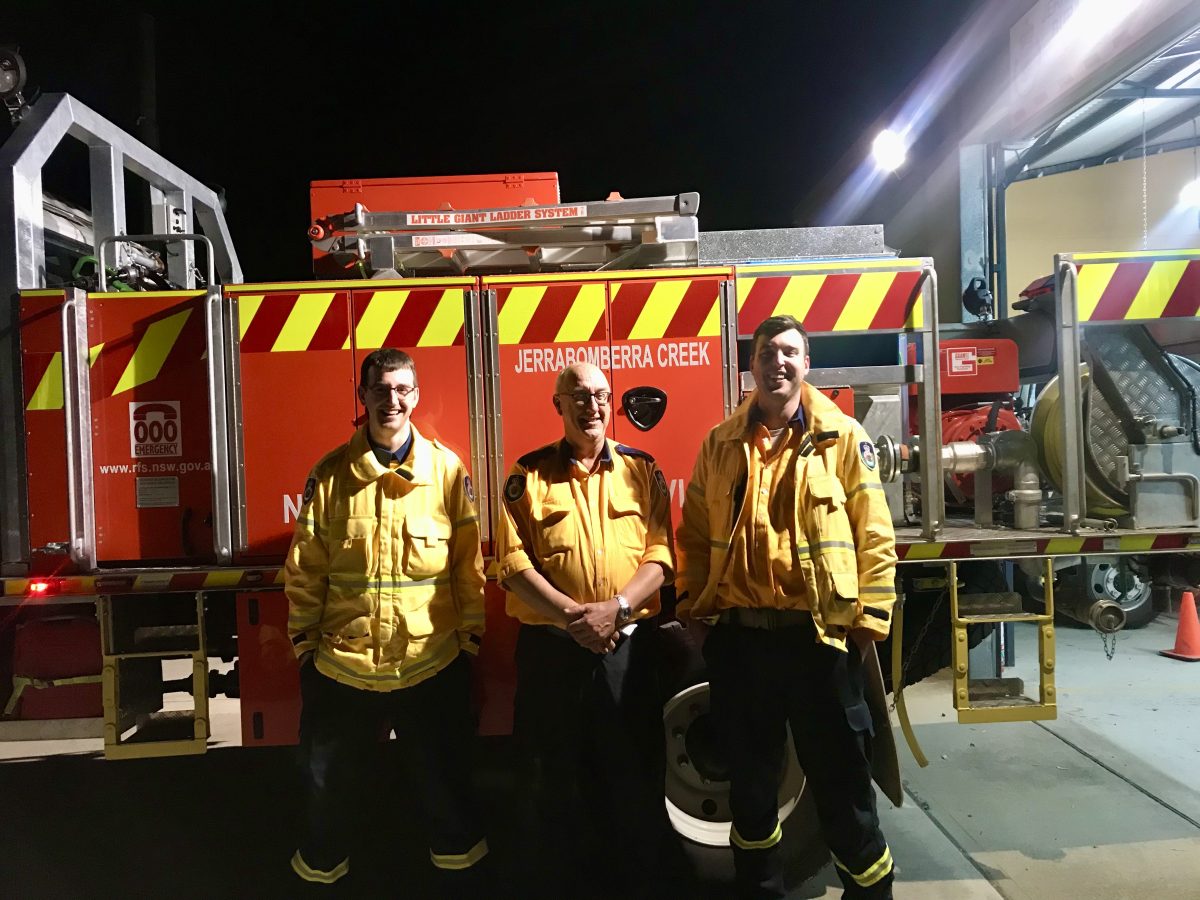 Firefighters in uniform standing in front of a Jerrabomberra firetruck