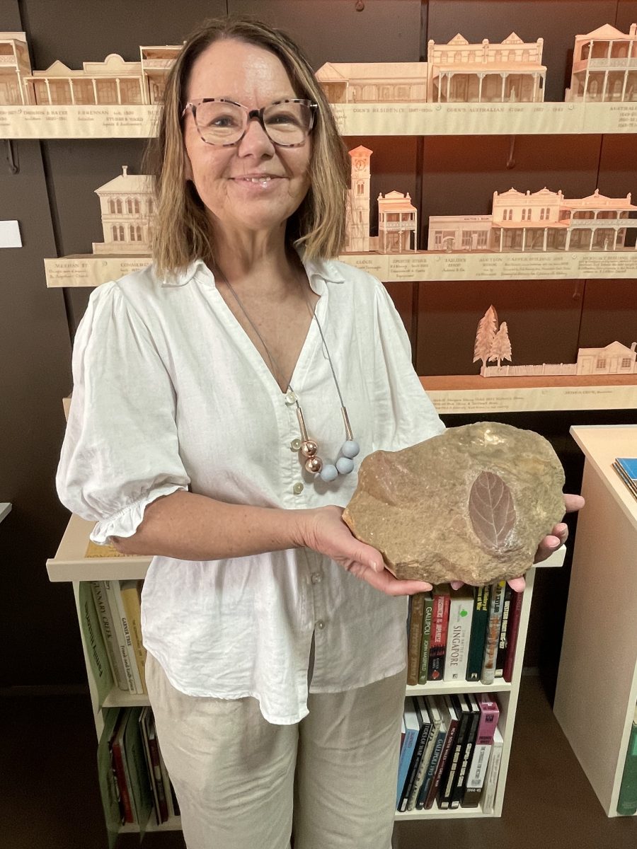 woman holding rock fossil