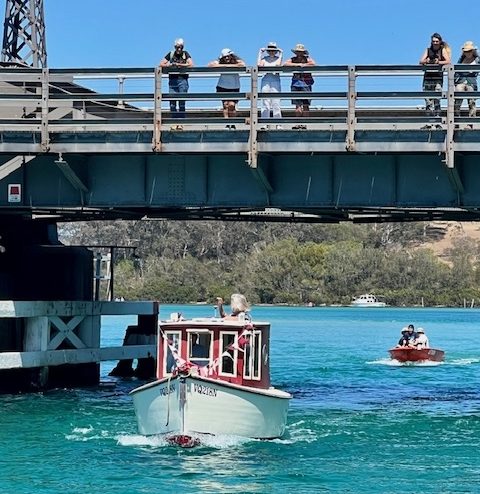 People watching the Grand Parade of the Narooma Boats Afloat Festival from Narooma Bridge.