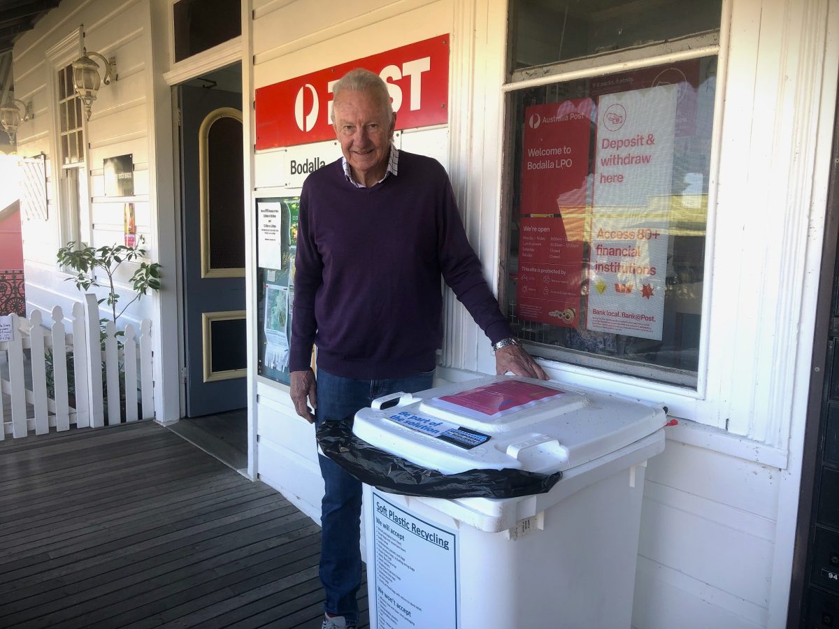 man and a recycling bin